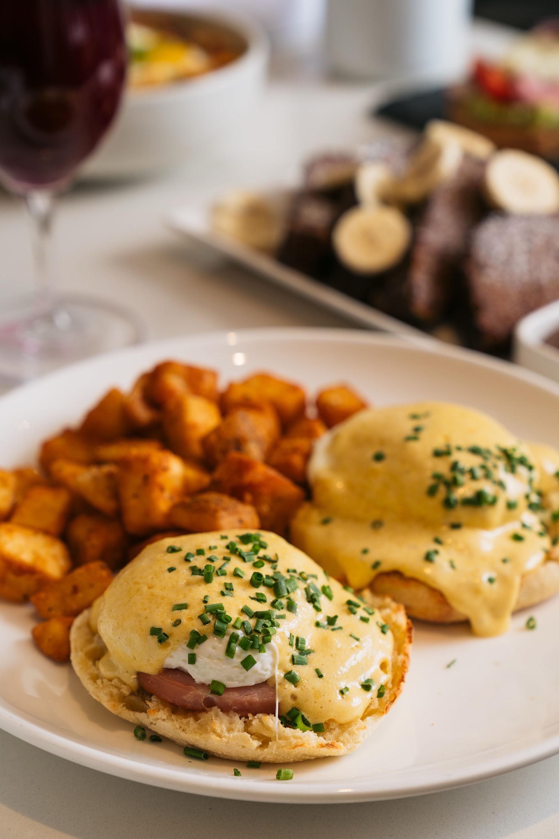 Elegant eggs benedict brunch with hollandaise and chive garnish