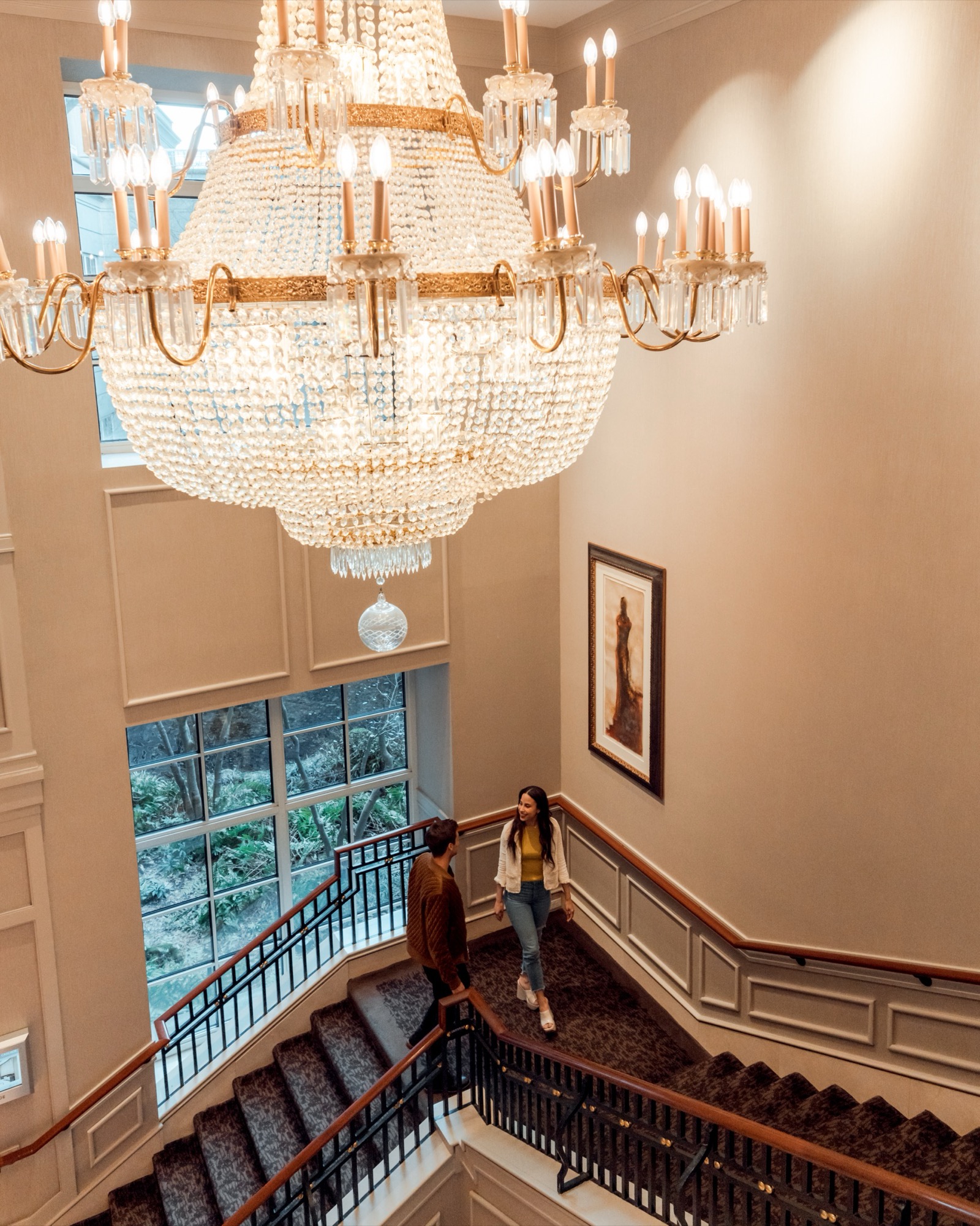 Grand crystal chandelier over an elegant hotel staircase